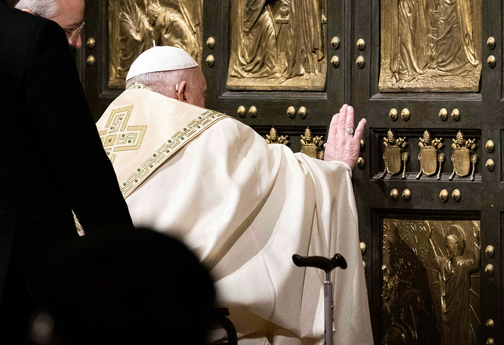 Pope Francis pushes open the Holy Door of St. Peter's Basilica at the Vatican Dec. 24, 2024, inaugurating the Holy Year 2025. (CNS/Cristian Gennari, pool)