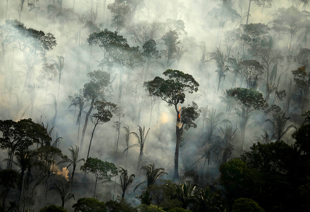 A file photo shows smoke billowing from a fire in an area of the Amazon rainforest near Porto Velho, Brazil. (OSV News/Reuters/Bruno Kelly)