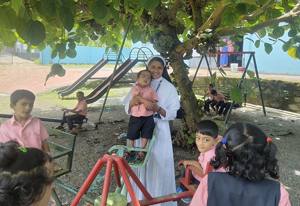 Sr. Anseena Memadathil interacts with children at the park on the Kripalaya Special School premises at Pulpally, Wayanad, Kerala, southwestern India. (George Kommattam)