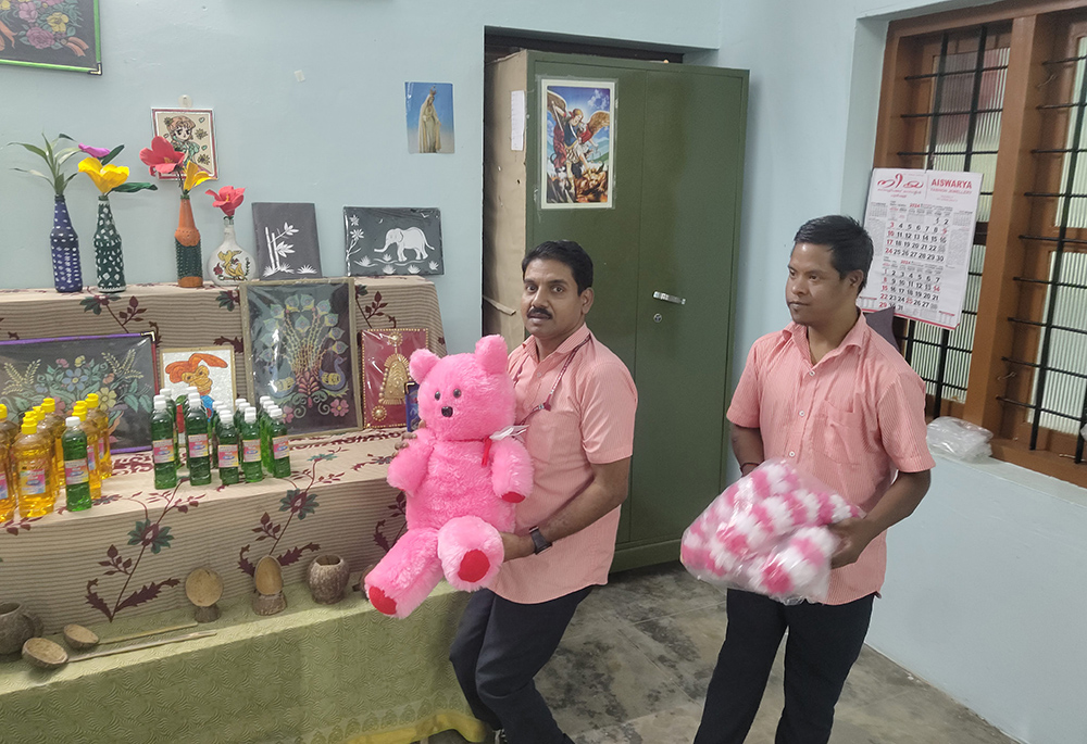 Ajith Kumar and Vinod Kumar, who both attend Kripalaya Special School, Pulpally, Wayanad, Kerala, southwestern India, showcase their creative works in the school's training room. (George Kommattam)