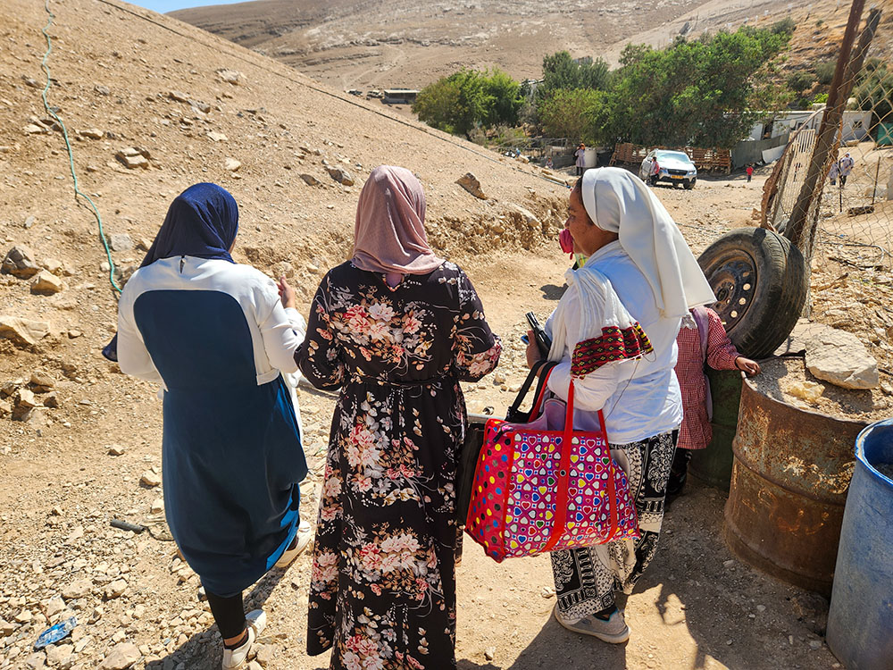 Comboni Sr. Cecilia Sierra, right, with two residents of the West Bank village of Abu-hindi. The Bedouin women did not wish to be identified in photos, worried about the potential harm that could pose to their communities. (GSR photo/Chris Herlinger)