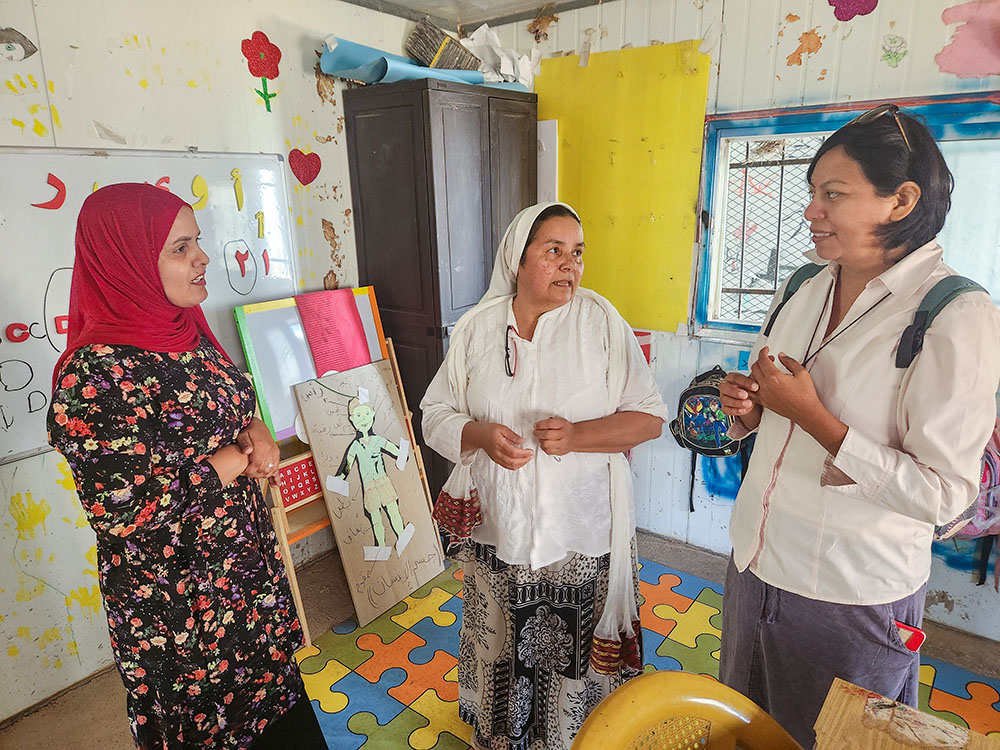 Comboni Srs. Cecilia Sierra, center, and Lourdes Garcia, right, speak to a teacher in the Bedouin West Bank community of Abu-hindi. (GSR photo/Chris Herlinger)