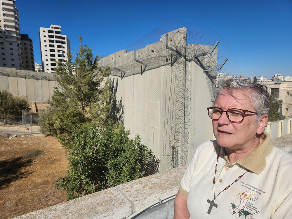 Comboni Sr. Mariolina Cattaneo on the roof terrace of the main Comboni residence in East Jerusalem, overlooking the concrete separation wall just yards away. The wall is about 440 miles long, and twice as high in some spots as the Berlin Wall. The segment near the Comboni residence was completed in 2009. (GSR photo/Chris Herlinger)
