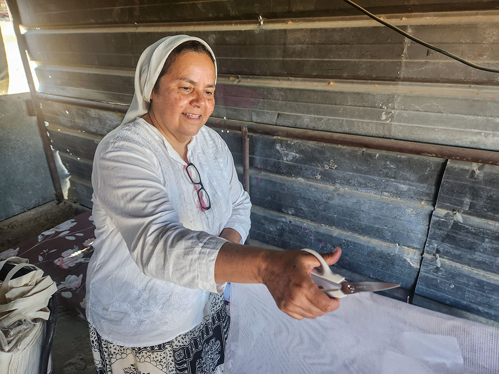 Comboni Sr. Cecilia Sierra prepares materials to be used for crafts made by Bedouin women in the West Bank village of Tabana. (GSR photo/Chris Herlinger)