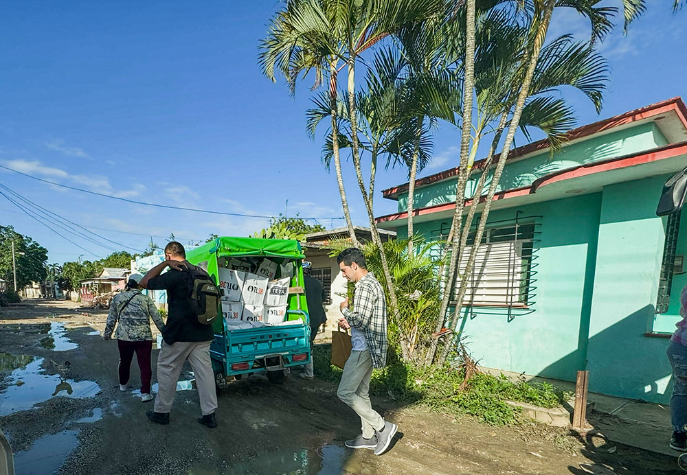 Catholic volunteers load a three-wheeled car with donations in Velasco, Cuba, Nov. 15, 2025, as they distribute donations for those affected by Hurricane Melissa at the end of October. (NCR photo/Rhina Guidos)