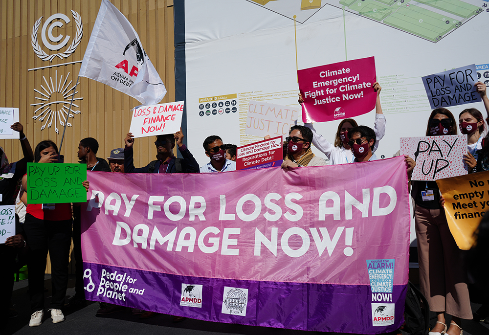  Climate activists, including faith leaders, demonstrate with banners during COP27, held Nov. 6-20, 2022, in Sharm El-Sheikh, Egypt. (NCR photo/Doreen Ajiambo)