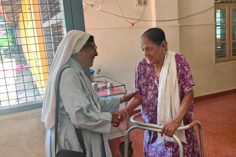 Queen of the Apostles Sr. Melania D'Souza comforts a senior citizen in the palliative care unit of Goretti Hospital in Udupi, a coastal town in the southwestern Indian state of Karnataka. (Thomas Scaria)