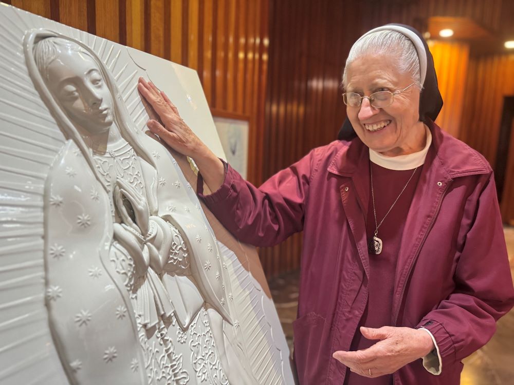Sr. María Celina Mota Campos moves toward a sculpture for the blind at the Basilica of Our Lady of Guadalupe in Mexico City Nov. 6.