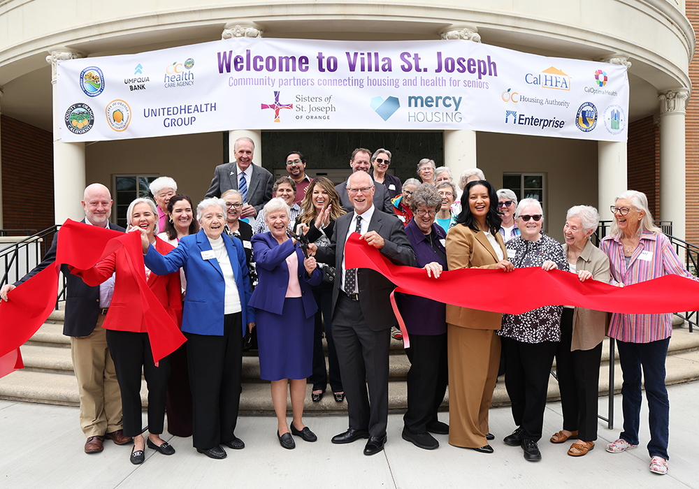 Officials cut the ribbon on Villa St. Joseph in Orange, California, on June 3, 2025, completing a project to convert the Sisters of St. Joseph of Orange motherhouse into senior housing. Second from left in the front row is Sr. Mary Bernadette McNulty, who shepherded the project. (Courtesy of the Sisters of St. Joseph of Orange/Sandy Huffaker)