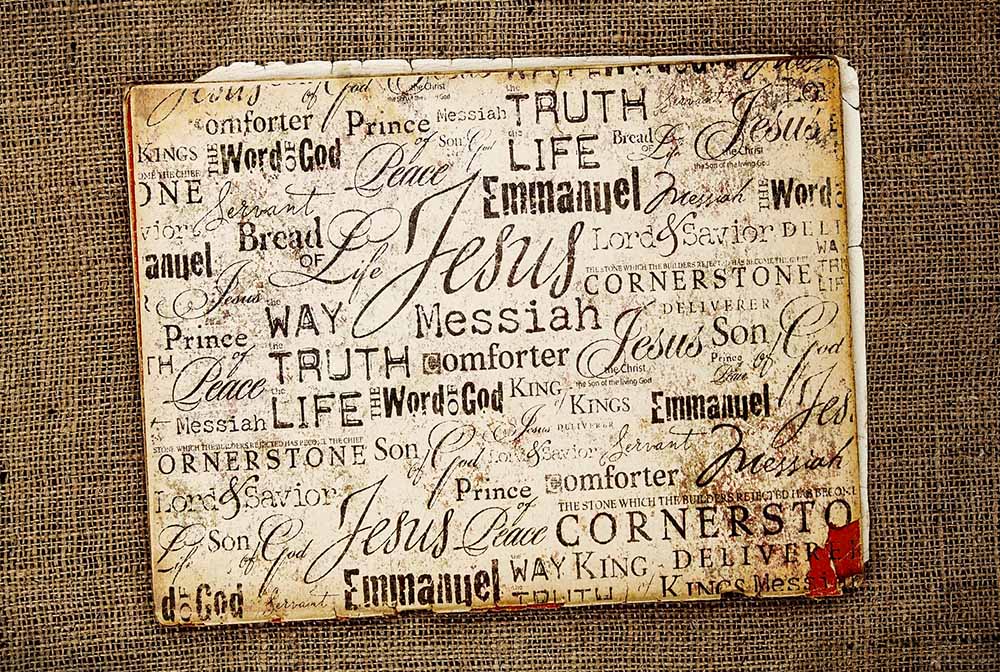 A collection of words for Jesus in different fonts, on a burlap background (Dreamstime/Genotar)
