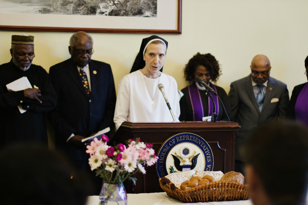Dominican Sr. Quincy Howard, Network's government relations fellow, offers the closing prayer at the interfaith service May 8 in the Cannon House Office Building in Washington, D.C. (NETWORK Lobby for Catholic Social Justice/Mehreen Karim) Dominican Sr. Quincy Howard, Network's government relations fellow, offers the closing prayer at the interfaith service May 8 in the Cannon House Office Building in Washington, D.C. (NETWORK Lobby for Catholic Social Justice/Mehreen Karim)