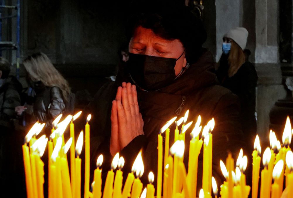 A woman prays at the Catholic Church of the Holy Apostles Peter and Paul on March 20 in Lviv, Ukraine. (CNS/Reuters/Zohra Bensemra)