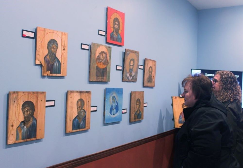 Attendees look at the "Icons on Ammo Boxes Exhibit," part of a fundraising event for Ukraine at Annunciation Byzantine Catholic Church in Homer Glen, Illinois, March 31. The event was sponsored by the parish, Rebuild Ukraine and CNEWA. (CNS/Laura Ieraci)