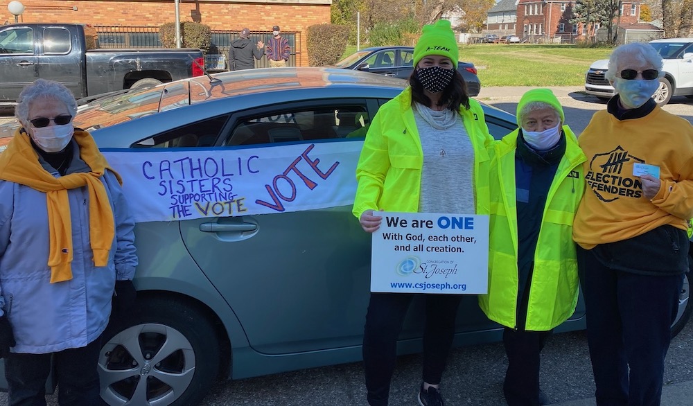 From left: St. Joseph Srs. Cathy Desantis, Erin McDonald, Nina Rodriguez and Marcella Clancy support the vote in Detroit Nov. 3. (Courtesy of Sr. Erin McDonald, CSJ)