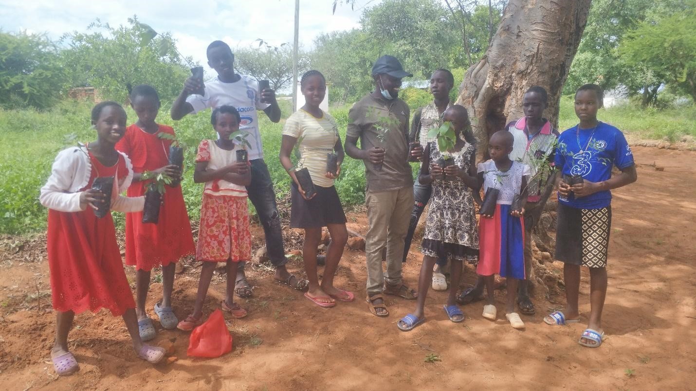 Youth with the Catholic Youth Network for Environmental Sustainability Africa work at a demonstration site in central Kenya. (Courtesy of CYNESA/Allen Ottaro)