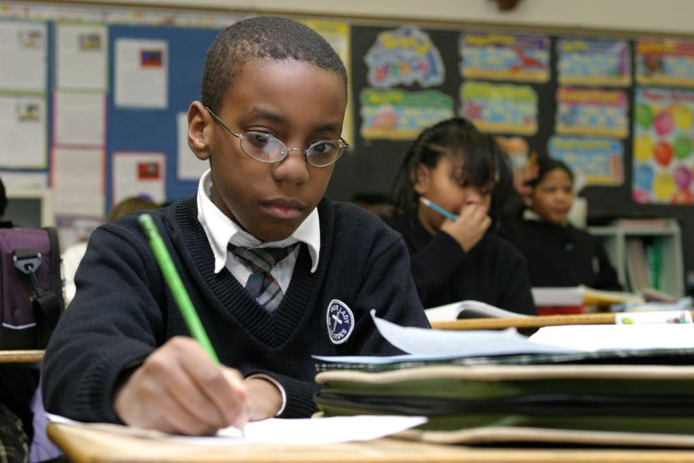 Fourth-grader Richard Blount works on a social studies assignment at Our Lady of Lourdes School in Massapequa Park, N.Y., Jan. 14, 2004. At the time, more than 2.5 million students were enrolled in 8,000 Catholic schools in the U.S.