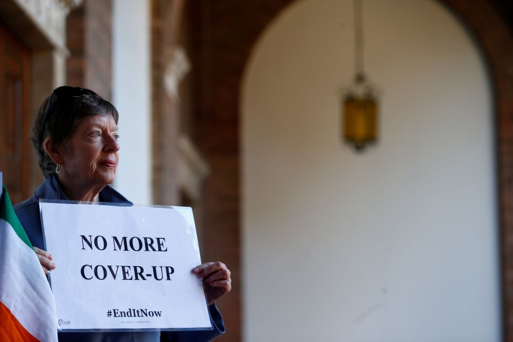 A woman demonstrates inside the headquarters of Benedictine order in Rome Feb. 22, 2019, during a four-day meeting on the protection of minors in the church at the Vatican. (CNS/Reuters/Yara Nardi)