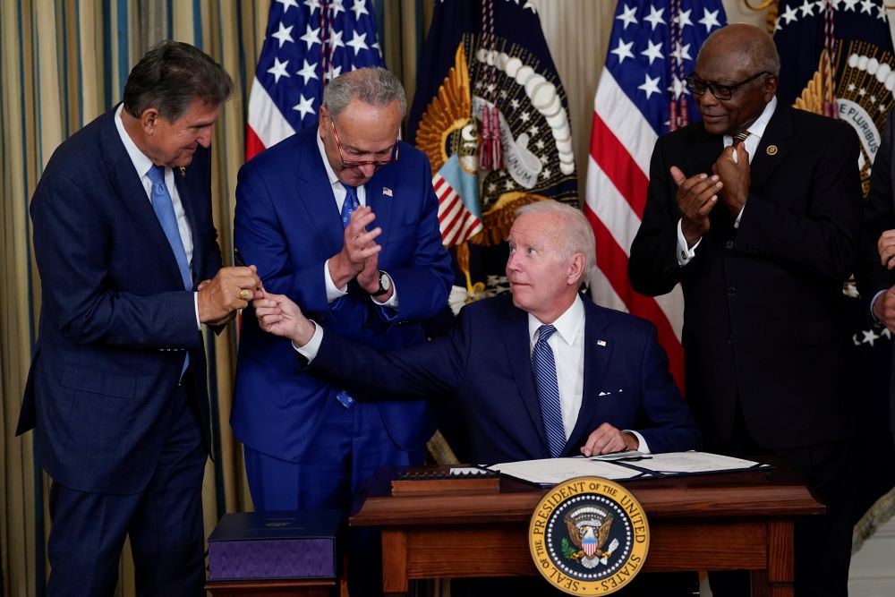 President Joe Biden hands the pen he used to sign the Democrats' landmark climate change and health care bill to Sen. Joe Manchin, D-W.Va., in the State Dining Room of the White House in Washington, Aug. 16. (AP/Susan Walsh)