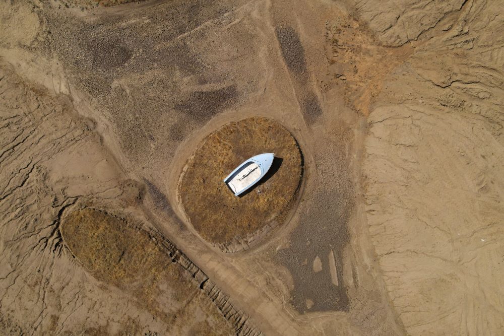 A boat in Madera, California, sits perched on a mound near Hensley Lake July 14, 2021, as soaring temperatures and drought continue to affect livestock and water supplies. (CNS/Reuters/David Swanson)