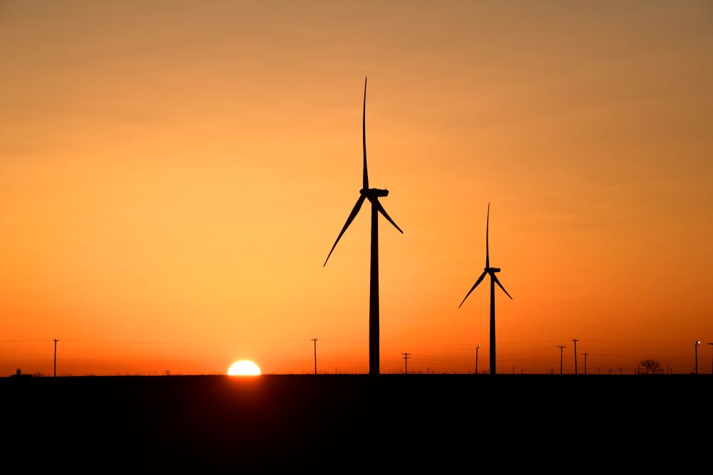 Wind turbines operate at sunrise in the Permian Basin oil and natural gas production area in Big Spring, Texas, Feb. 12, 2019. (CNS/Reuters/Nick Oxford)