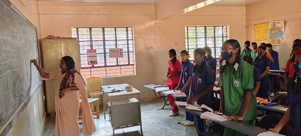 Sr. Deva Priya, at chalkboard, of the Sisters of St. Joseph of Tarbes teaches in a school on the Sumanahalli campus in Bengaluru, India. (Thomas Scaria)