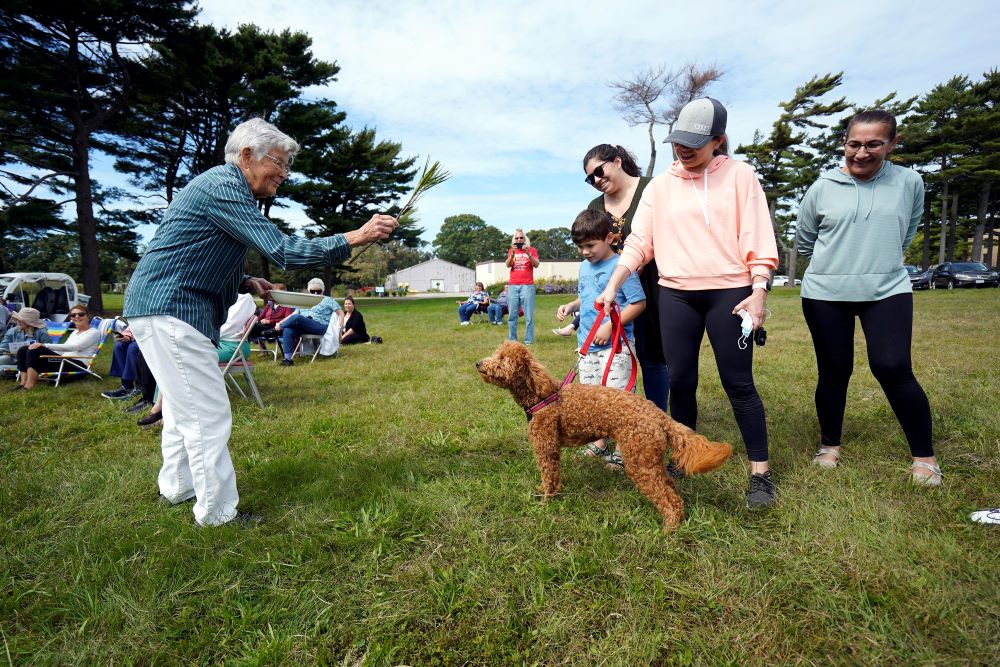 Josephite Sr. Mary Lou Buser of Brentwood, New York, blesses Ellie, a Goldendoodle, during a prayer service marking the Season of Creation at the Sisters of St. Joseph motherhouse Oct. 3, 2021. (CNS photo/Gregory A. Shemitz)