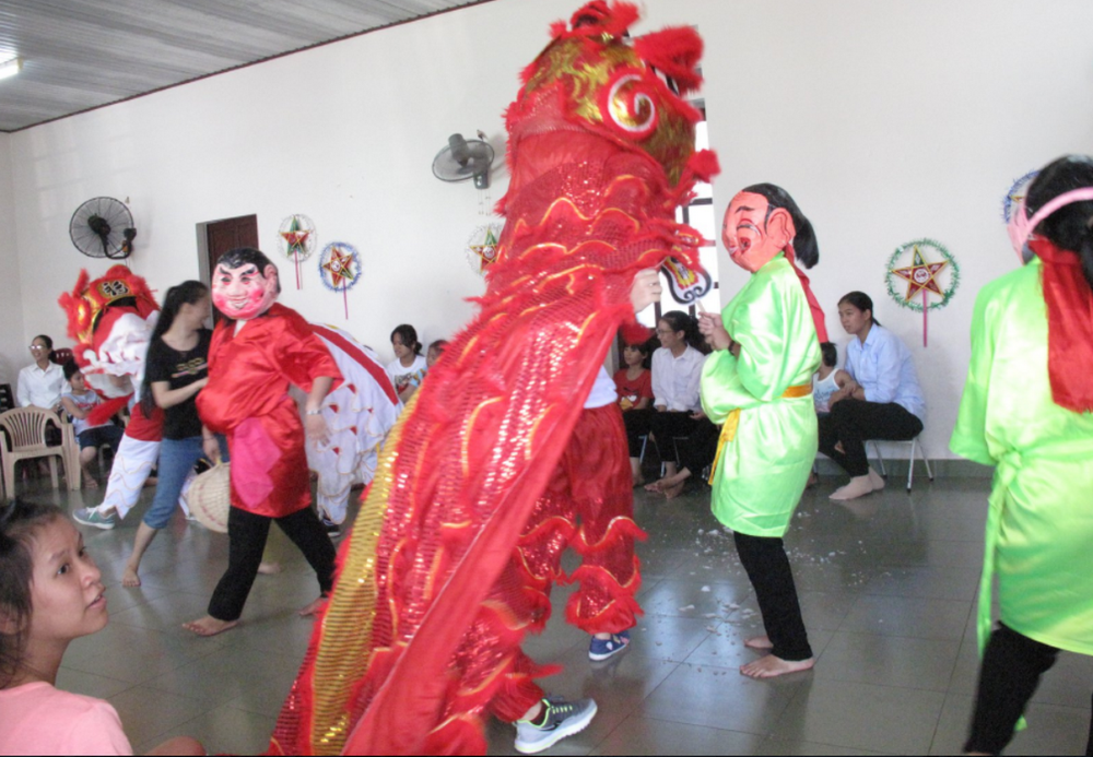 Five sisters of the Daughters of Our Lady of the Visitation perform a lion dance in colorful costumes to bring good luck and fortune to 30 children in their community in the Huong Thuy district of Thua Thien Hue province Sept. 7. 