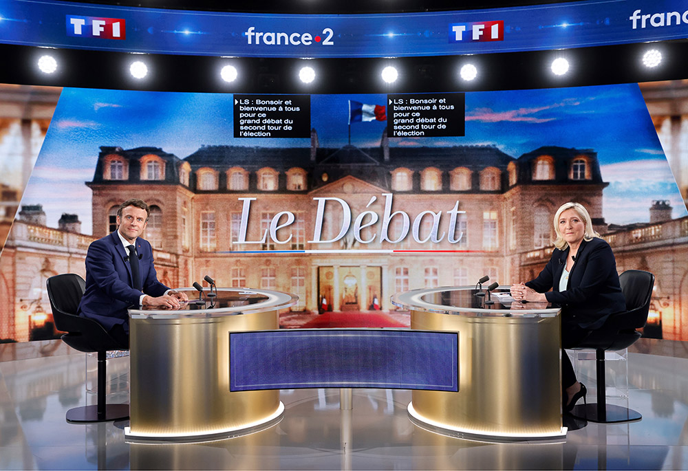 Centrist candidate and French President Emmanuel Macron, left, and far-right contender Marine Le Pen pose before a televised debate April 20 in La Plaine-Saint-Denis, outside Paris. (Ludovic Marin, Pool via AP)