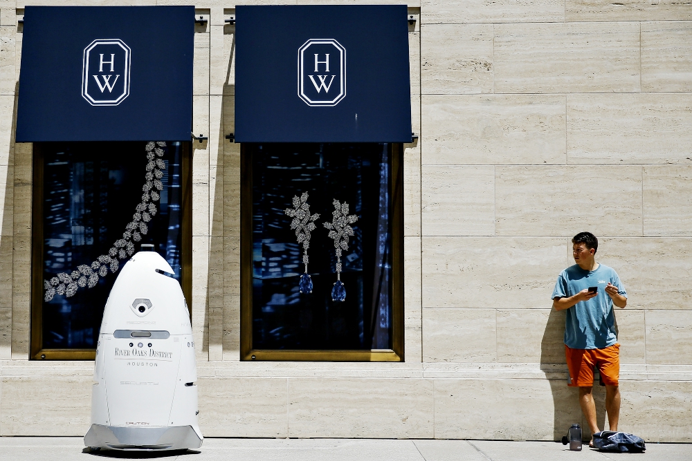 A new security robot drives toward Daniel Webb as it patrols the sidewalks and parking garage of the River Oaks District shopping complex Aug. 18 in Houston. (AP/Houston Chronicle/Michael Ciaglo) A new security robot drives toward Daniel Webb as it patrols the sidewalks and parking garage of the River Oaks District shopping complex Aug. 18 in Houston. (AP/Houston Chronicle/Michael Ciaglo)