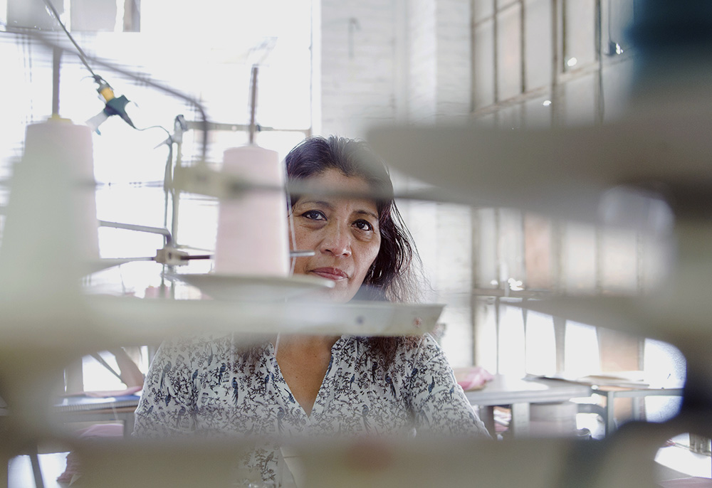 A worker sews Fashion Nova clothing in a garment factory in downtown Los Angeles on April 1, 2019. (AP/GDA via AP Images/The New York Times/Jessica Pons)