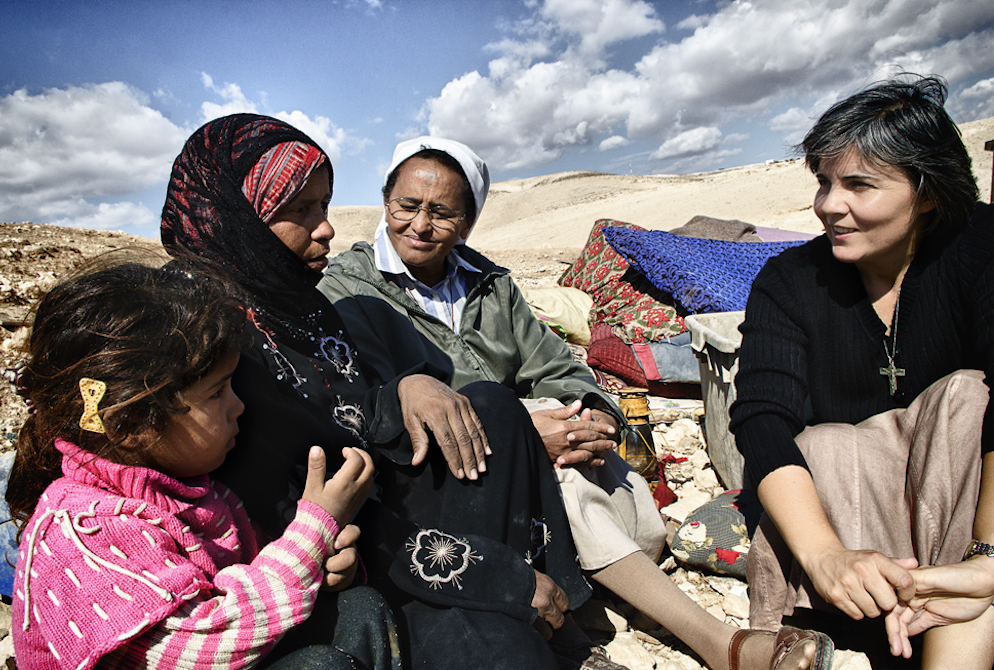 Comboni Sr. Alicia Vacas Moro, right, with Sr. Azezet Habtezghi, center, and a Bedouin family in the desert of Juda on the West Bank after the family's home had been demolished by Israel Defense Forces in 2013 (Courtesy of Sr. Alicia Vacas Moro)