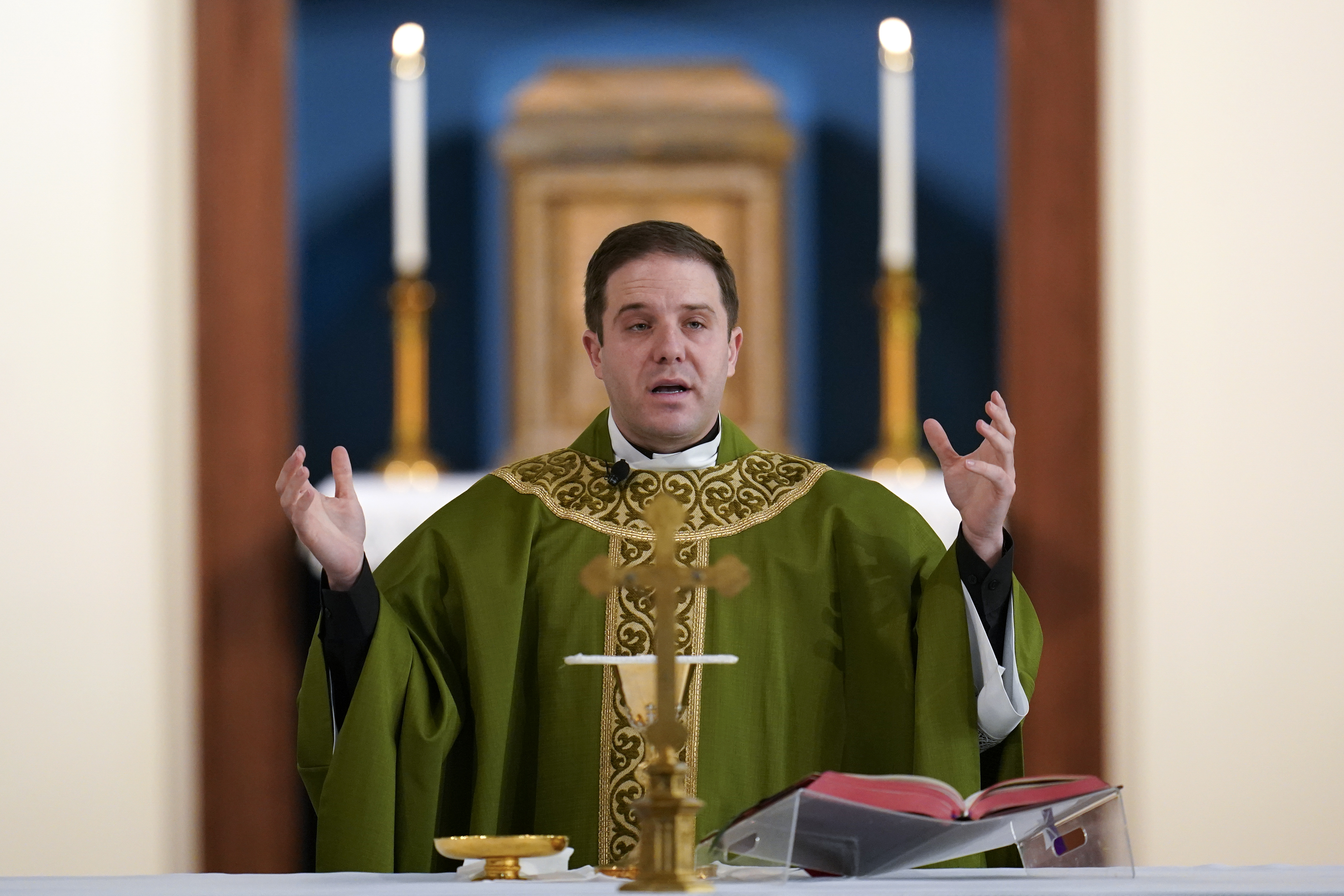 Father Matthew Hood celebrates mass at Our Lady of the Rosary church Friday, Feb. 18, 2022, in Detroit. (AP Photo/Paul Sancya) Father Matthew Hood celebrates mass at Our Lady of the Rosary church Friday, Feb. 18, 2022, in Detroit. (AP Photo/Paul Sancya)