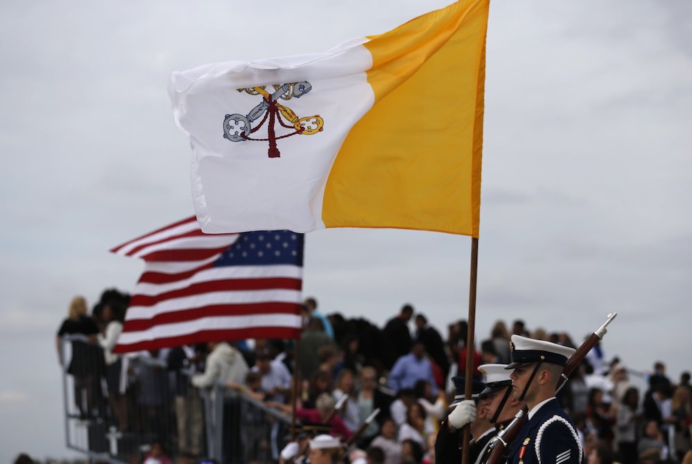 Vatican and U.S. flags are held by a military color guard during ceremonies welcoming Pope Francis upon his arrival at Joint Base Andrews outside Washington Sept. 22, 2015. (CNS/Reuters/Jonathan Ernst)