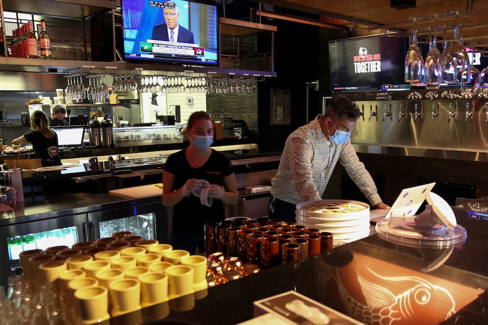 People in Miami work at a restaurant Aug. 31, 2020, during the coronavirus pandemic. (CNS/Reuters/Marco Bello)