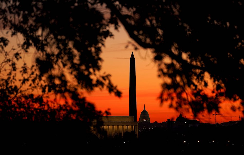 The sun rises behind the U.S. Capitol, the Washington Monument and the Lincoln Memorial in Washington Nov. 19. (CNS/Reuters/Kevin Lamarque) The sun rises behind the U.S. Capitol, the Washington Monument and the Lincoln Memorial in Washington Nov. 19. (CNS/Reuters/Kevin Lamarque)