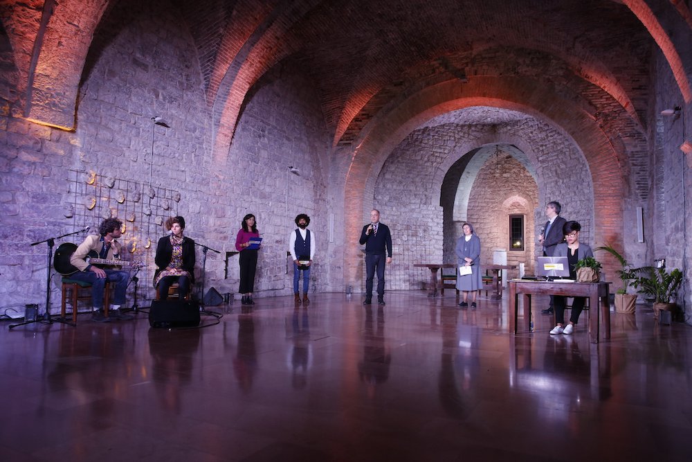 People participate in the "Economy of Francesco" virtual meeting Nov. 21. Organizers were situated in the Basilica of St. Francis of Assisi in Assisi, Italy. (CNS/Economy of Francesco)