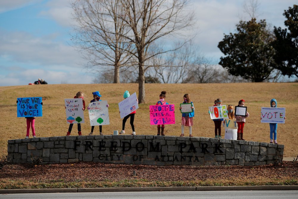 Girl Scouts in Atlanta hold signs urging residents to vote in the runoff election for both of Georgia's U.S. Senate seats Jan. 3, 2021. (CNS/Reuters/Brian Snyder) Girl Scouts in Atlanta hold signs urging residents to vote in the runoff election for both of Georgia's U.S. Senate seats Jan. 3, 2021. (CNS/Reuters/Brian Snyder)