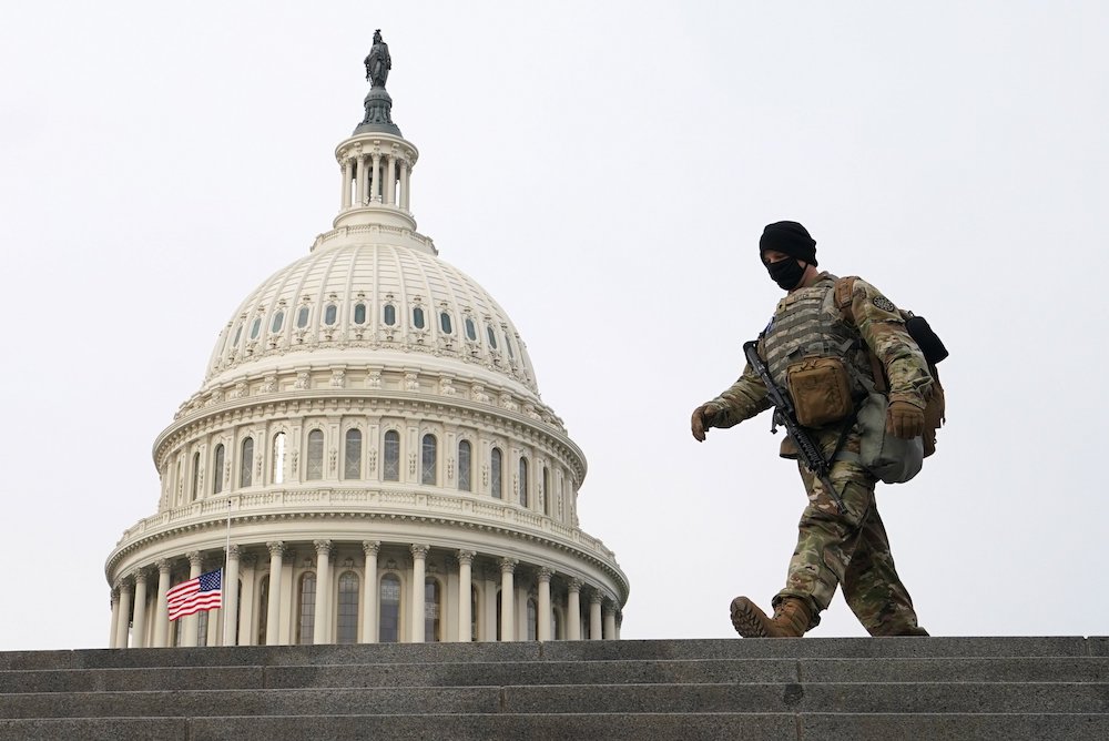 A member of the National Guard walks the grounds of the U.S. Capitol on the second day of former President Donald Trump's second impeachment trial in Washington Feb. 10, 2021. (CNS/Reuters/Kevin Lamarque)