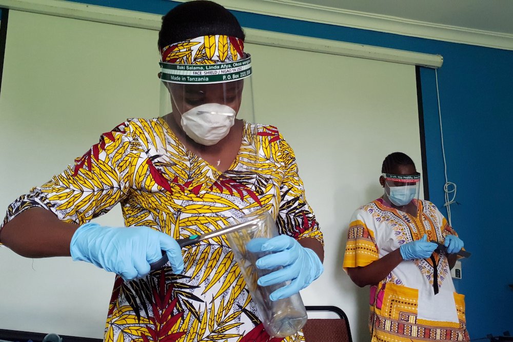 Workers prepare protective face shields from recycled plastics at the Zaidi Recyclers workshop in Dar es Salaam, Tanzania, May 21, 2020. (CNS/Reuters)