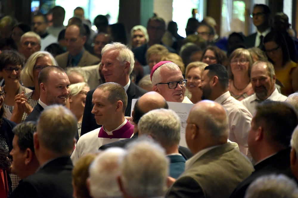 Bishop Donald Hying displays the papal bull about his appointment to head the Diocese of Madison, Wisconsin, during his installation Mass June 25, 2019, at St. Maria Goretti Church in Madison. (CNS/Northwest Indiana Catholic/Anthony D. Alonzo)