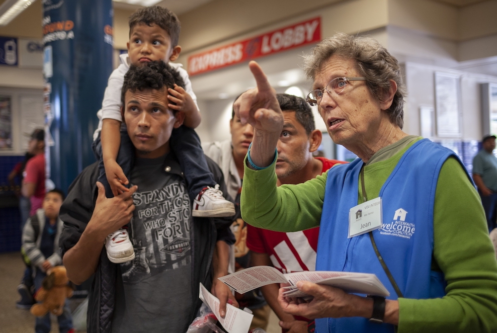 As an Interfaith Welcome Coalition volunteer, Sr. Jean Durel, a Sister of Charity of the Incarnate Word, helps Cyrilo Garcia, his son, Kelvin Naum, 3, and Juan Jose Nunez June 18, 2019, at the San Antonio Greyhound station. (GSR file photo/Nuri Vallbona)