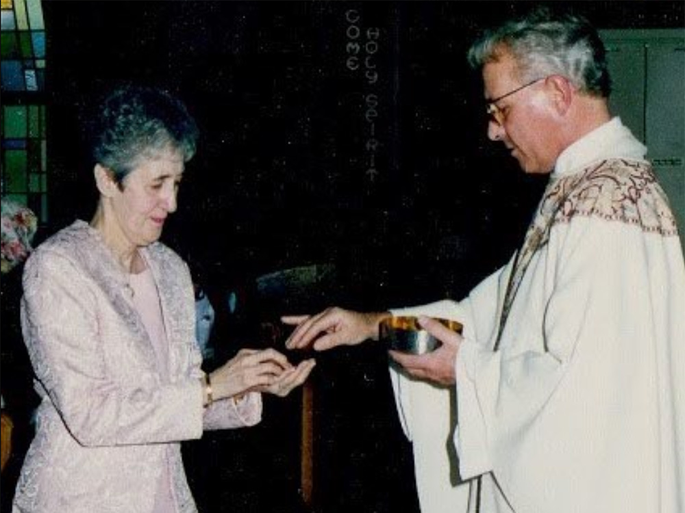 The author's mother, Carmen Nanko, receives Communion from Fr. Robert Poveromo. (Courtesy of Chip and Karen Nanko)