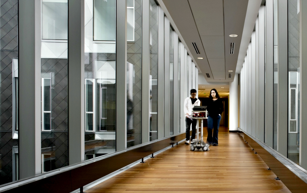 A mobile CoBot, or collaborative robot, leads students across a walkway bridge on the campus of Carnegie Mellon University in Pittsburgh. (Carnegie Mellon University) A mobile CoBot, or collaborative robot, leads students across a walkway bridge on the campus of Carnegie Mellon University in Pittsburgh. (Carnegie Mellon University)