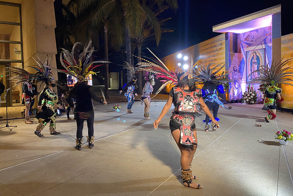 Aztec dancers wearing face masks honor Our Lady of Guadalupe in front of a shrine designed by artist Lalo Garcia in the courtyard of the Cathedral of Our Lady of the Angels in downtown Los Angeles. The performance, part of a Dec. 9 press event, was taped 