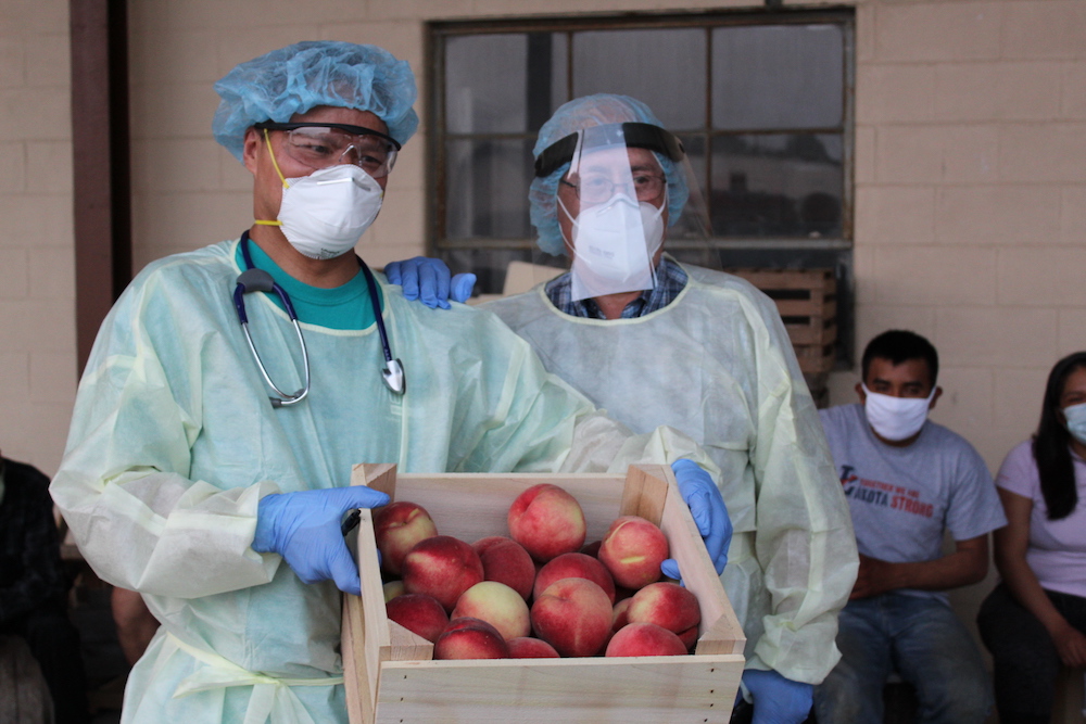 Left, physician Dr. Richard Paat and Baldemar Velasquez, founder of the Farm Labor Organizing Committee, at Eshleman Farm in Clyde, Ohio (Kate Oatis)