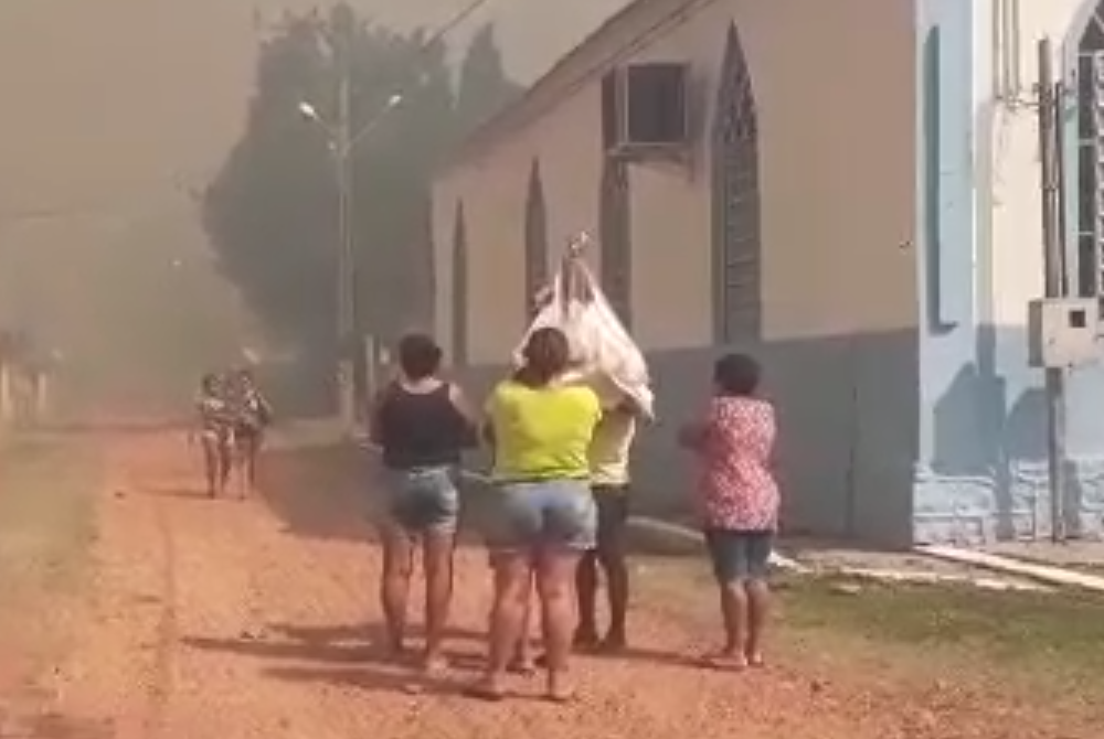 Community leader Edir Silva and others removed a 200-year-old statue of Our Lady of Mount Carmel out of their local chapel Sept. 7, as a wildfire threatened to engulf the village of Forte Coimbra. (Courtesy of Edir Silva)