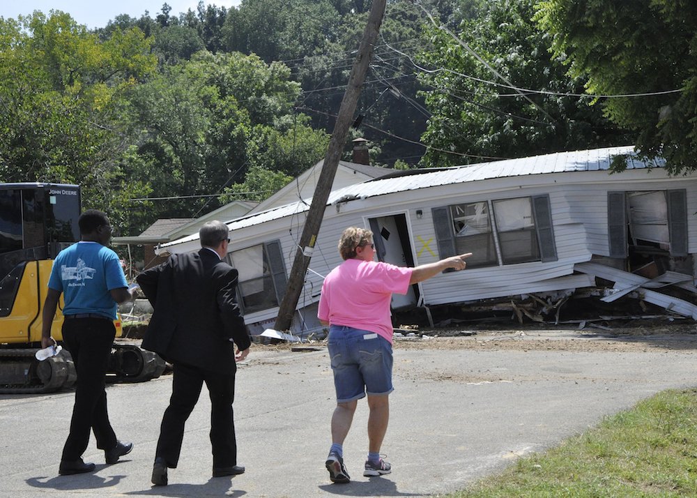 Bishop J. Mark Spalding of Nashville, Tennessee, visits flood victims in Waverly, Tennessee, Aug. 24. (CNS photo/Katie Peterson, Tennessee Register)