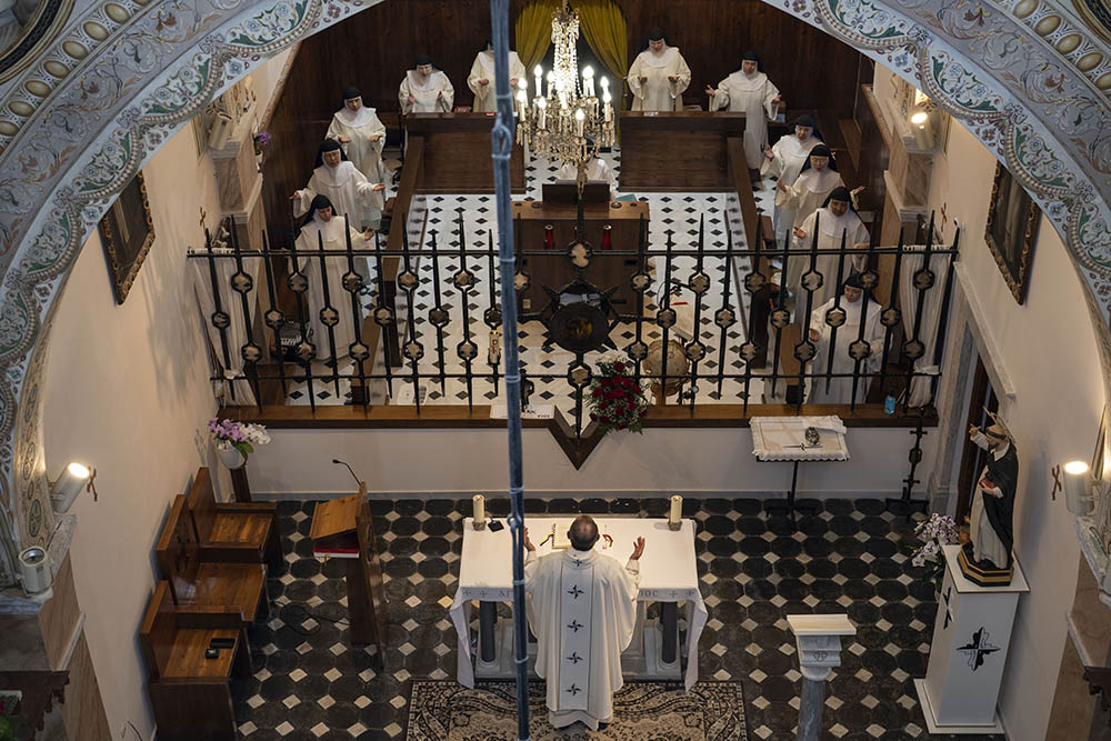 A priest celebrates Mass with cloistered nuns in the Catholic Monastery of St. Catherine on the Greek island of Santorini June 14. (AP/Petros Giannakouris)