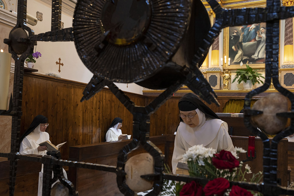 Sister María de Jesús bows her head as Sister María Flor de la Eucaristía, left front, and Sister Amparo de María pray during Mass in the Catholic Monastery of St. Catherine on the Greek island of Santorini June 14. (AP/Petros Giannakouris)