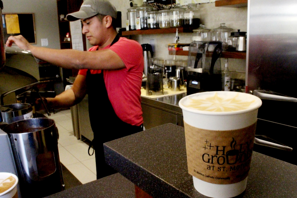 Paco Orocco, 25, creates a work of art on each coffee at Holy Grounds at St. Monica Catholic Community in Santa Monica, California. All the baristas the church hires for the café are formerly incarcerated youth. (Heather Adams)